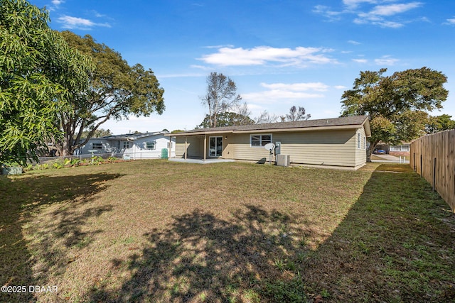 back of property with a yard and a patio area