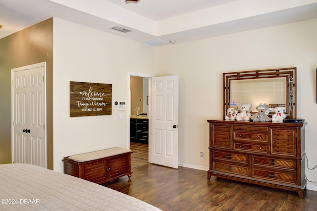 bedroom with baseboards, visible vents, and dark wood-style flooring