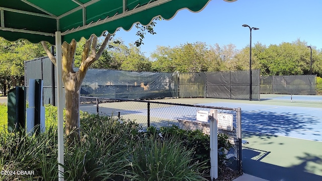 view of sport court featuring fence