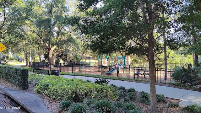 surrounding community featuring playground community and fence