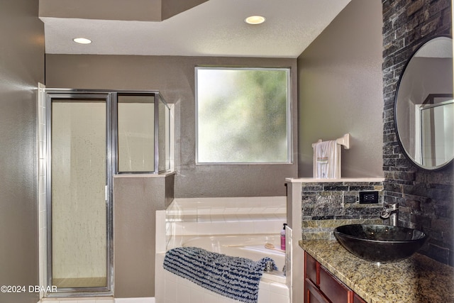 full bath with a garden tub, a textured ceiling, vanity, a shower stall, and recessed lighting