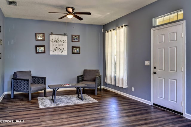 sitting room with plenty of natural light, wood finished floors, visible vents, and baseboards