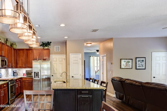 kitchen with open floor plan, appliances with stainless steel finishes, dark wood finished floors, and visible vents