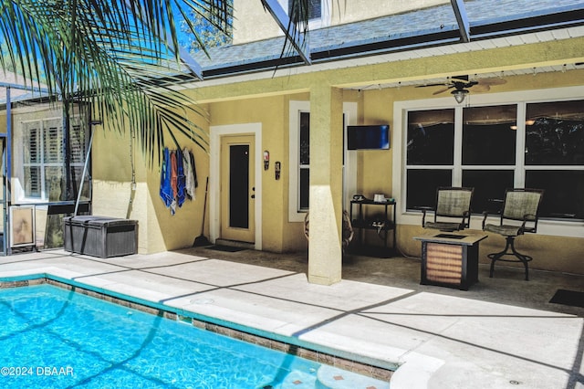 pool featuring a lanai, a patio area, and ceiling fan