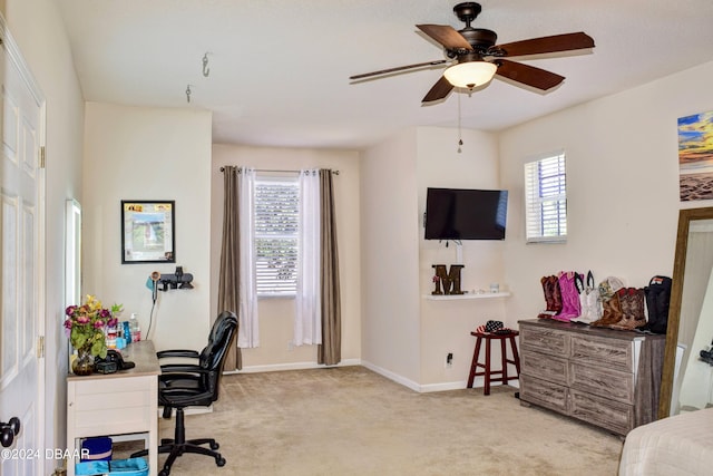 carpeted home office featuring ceiling fan and baseboards