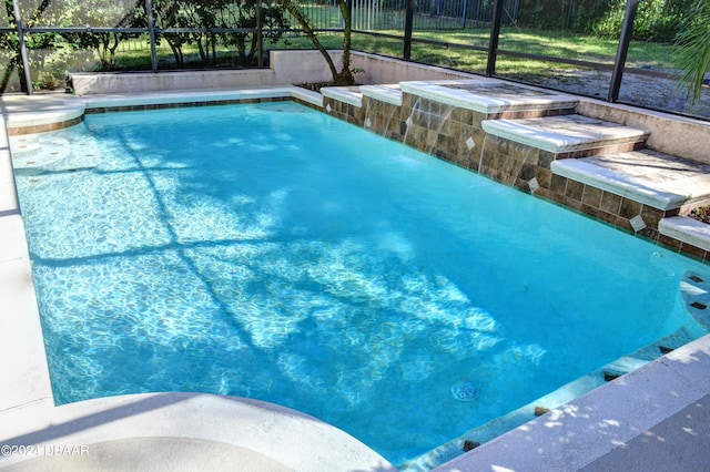 outdoor pool featuring glass enclosure