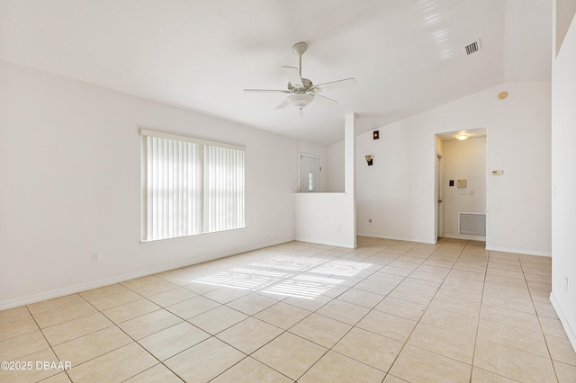 empty room with lofted ceiling, light tile patterned flooring, and ceiling fan