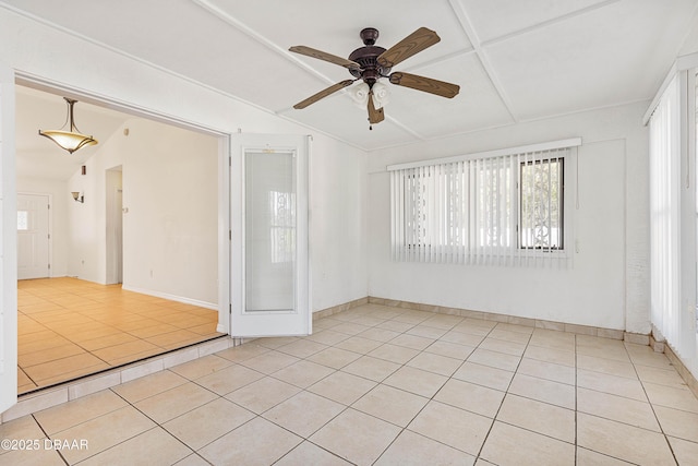 empty room featuring ceiling fan, light tile patterned floors, and lofted ceiling