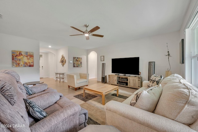 living room with light wood-type flooring and ceiling fan