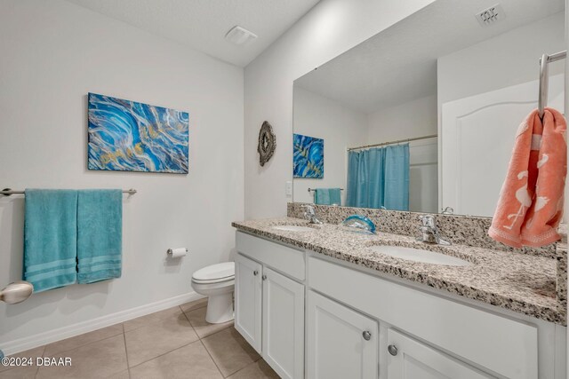 350 Sunset Point Dr, Ormond Beach, FL 32174 - full bath with toilet, double vanity, baseboards, tile patterned floors, and curtained shower