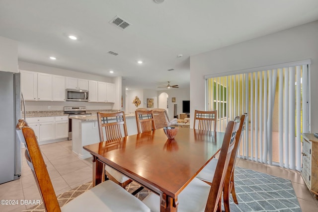 tiled dining area featuring ceiling fan