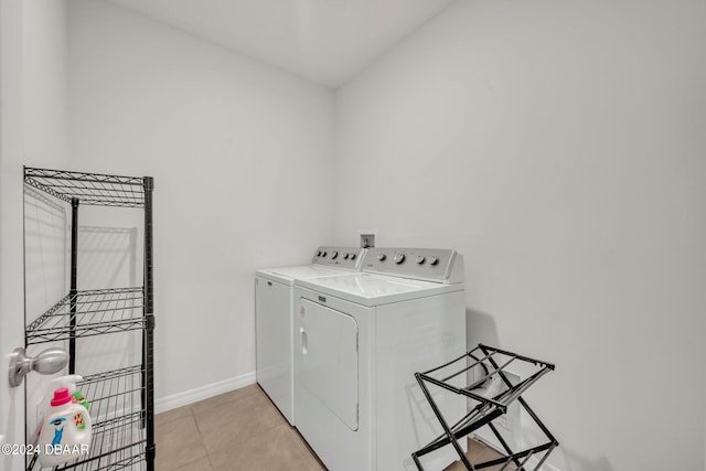 laundry room with light tile patterned floors and independent washer and dryer