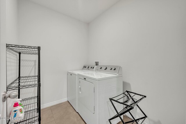 350 Sunset Point Dr, Ormond Beach, FL 32174 - laundry room with washer and clothes dryer, baseboards, and light tile patterned flooring
