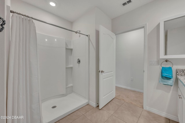 bathroom featuring tile patterned flooring, vanity, and a shower with curtain