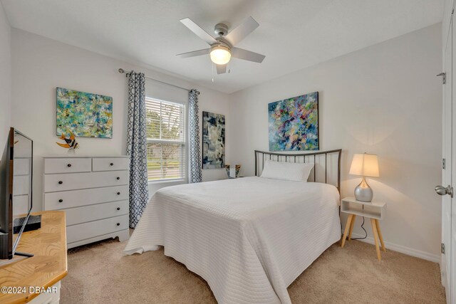350 Sunset Point Dr, Ormond Beach, FL 32174 - bedroom featuring light carpet, baseboards, and a ceiling fan