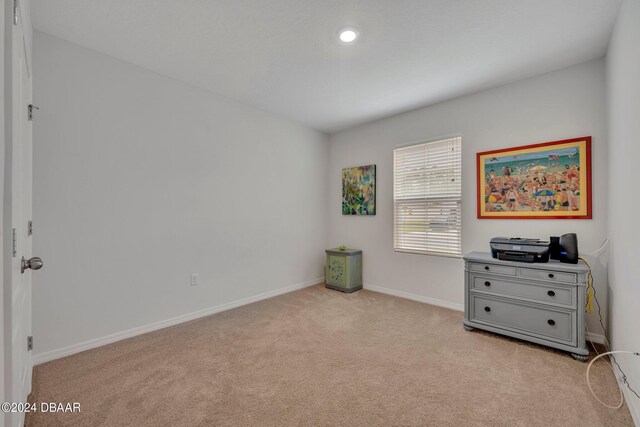 350 Sunset Point Dr, Ormond Beach, FL 32174 - bedroom with light colored carpet and baseboards