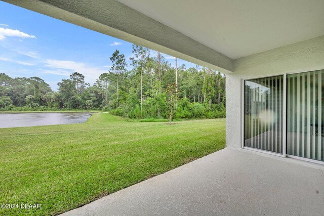 350 Sunset Point Dr, Ormond Beach, FL 32174 - view of grassy yard featuring a patio area and a water view