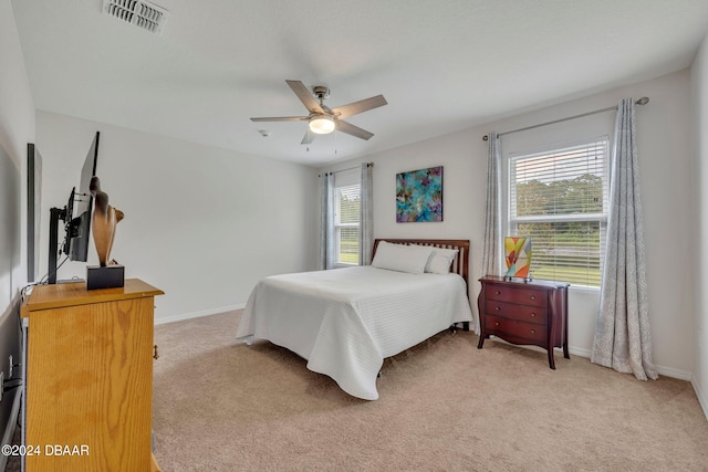 bedroom featuring light colored carpet and ceiling fan