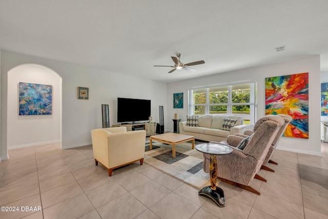 tiled living room featuring ceiling fan