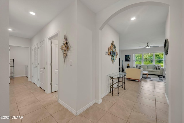 350 Sunset Point Dr, Ormond Beach, FL 32174 - hall with arched walkways, light tile patterned floors, recessed lighting, and baseboards