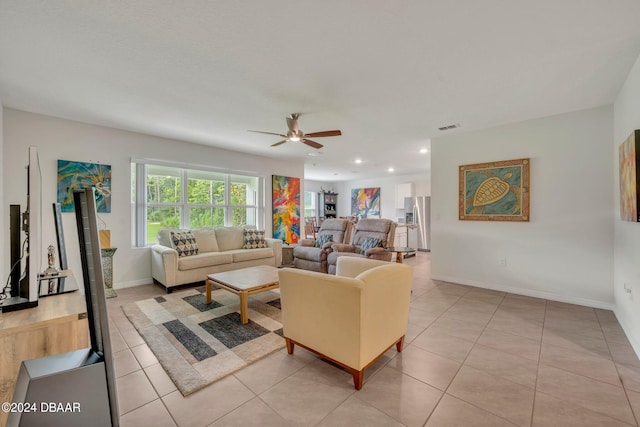 living room featuring light tile patterned floors and ceiling fan