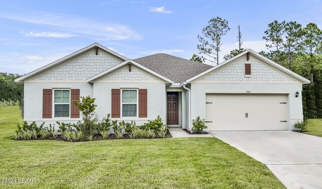 view of front of house featuring a front yard and a garage