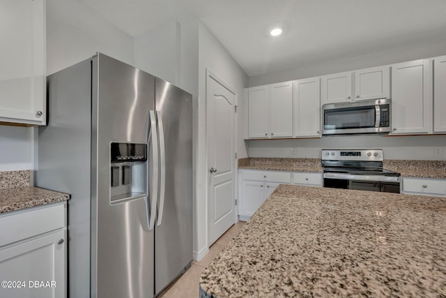 350 Sunset Point Dr, Ormond Beach, FL 32174 - kitchen with stainless steel appliances, white cabinets, light stone countertops, and recessed lighting