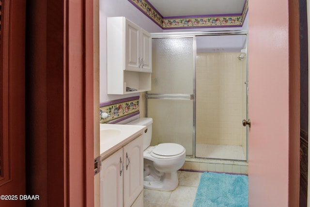 bathroom featuring vanity, tile patterned flooring, toilet, and a shower with shower door