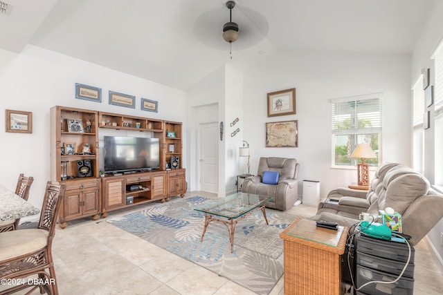 living room with high vaulted ceiling, light tile patterned floors, and ceiling fan