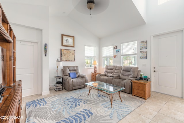 living room featuring high vaulted ceiling, ceiling fan, and light tile patterned floors