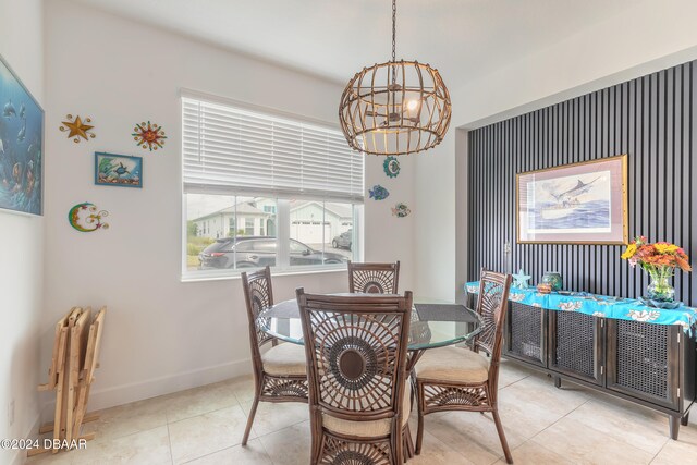 dining area with light tile patterned floors and an inviting chandelier