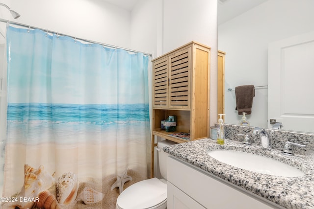 bathroom featuring curtained shower, vanity, and toilet