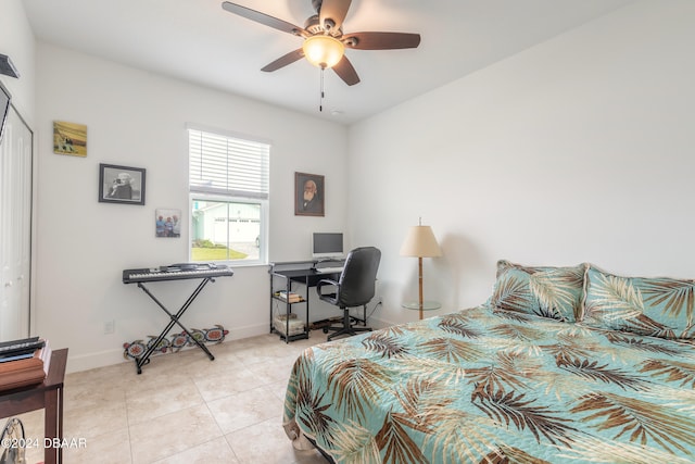 tiled bedroom with ceiling fan and a closet