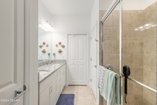 bathroom with tile patterned flooring, vanity, and a shower with shower door