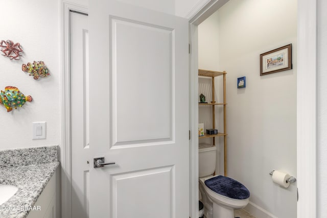 bathroom featuring toilet and vanity