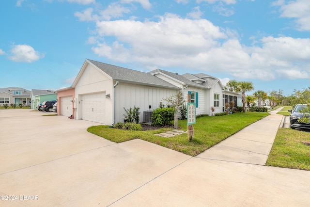 view of home's exterior featuring central AC, a garage, and a yard