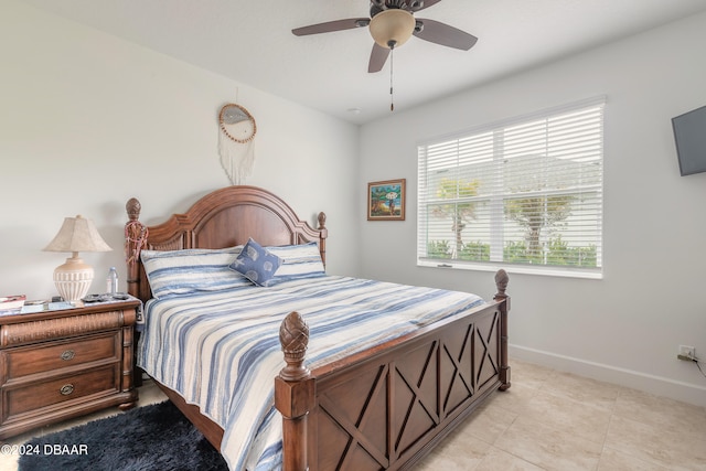 bedroom with ceiling fan and light tile patterned floors