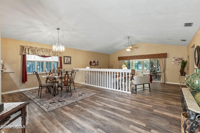 dining area with ceiling fan with notable chandelier, plenty of natural light, dark wood-type flooring, and lofted ceiling