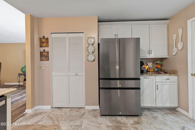 kitchen with white cabinetry, appliances with stainless steel finishes, and stone countertops