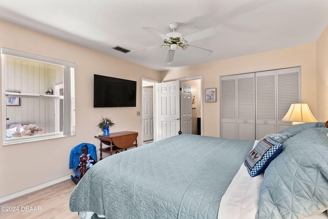 bedroom featuring wood-type flooring, ceiling fan, and a closet