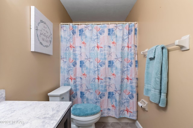 bathroom featuring toilet, a shower with curtain, vanity, and tile patterned floors