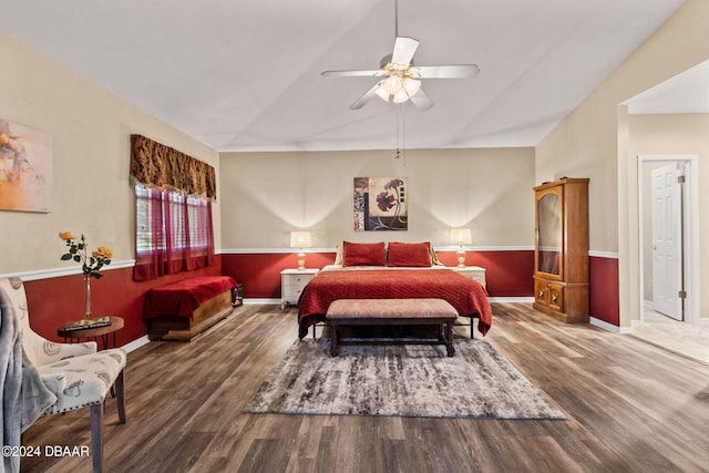 bedroom with ceiling fan, wood-type flooring, and vaulted ceiling