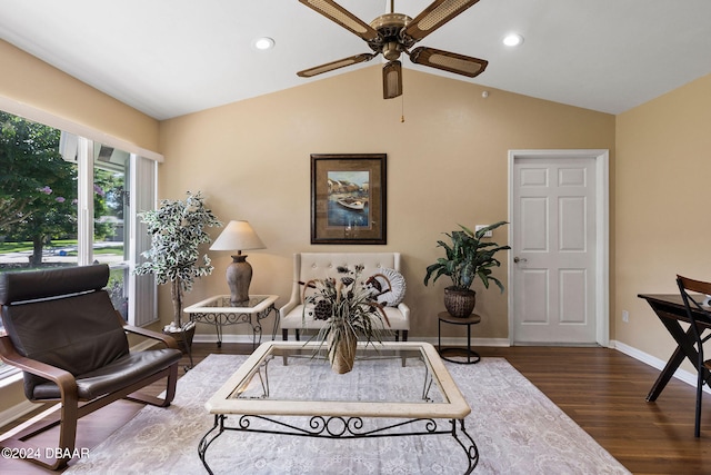 living area featuring lofted ceiling, dark hardwood / wood-style floors, and ceiling fan