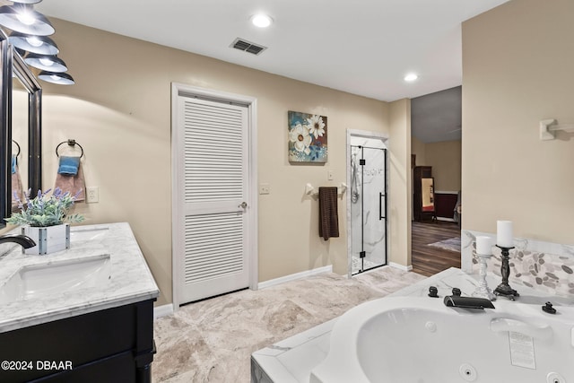 bathroom featuring hardwood / wood-style floors, vanity, and separate shower and tub