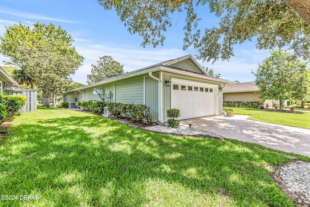 view of side of home featuring a lawn and a garage