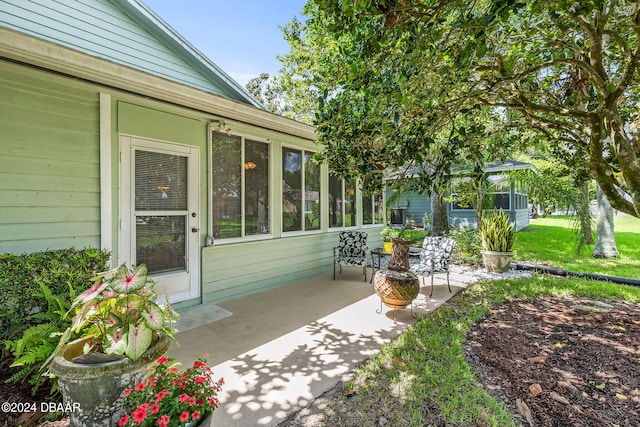 view of patio / terrace featuring a sunroom