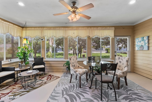 sunroom featuring ceiling fan