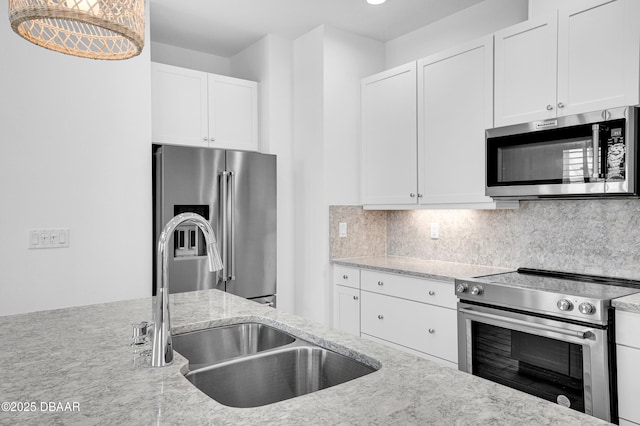 232 Ocean Hammock Loop, Daytona Beach, FL 32124 - kitchen featuring white cabinets, light stone countertops, stainless steel appliances, and a sink