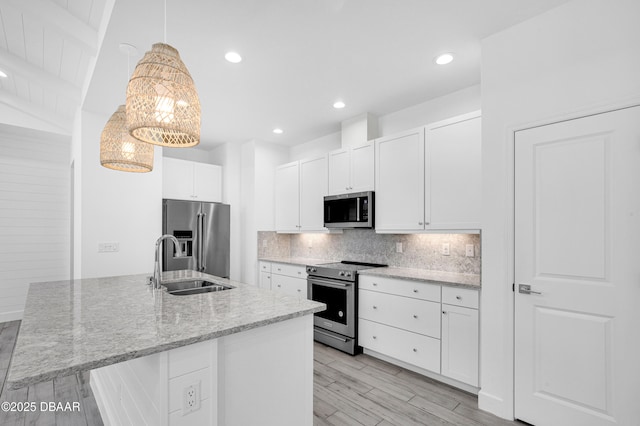 232 Ocean Hammock Loop, Daytona Beach, FL 32124 - kitchen with white cabinets, decorative backsplash, stainless steel appliances, and a sink