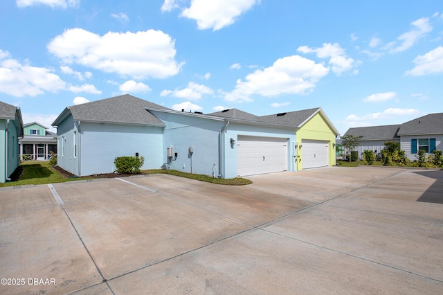 232 Ocean Hammock Loop, Daytona Beach, FL 32124 - view of property exterior with stucco siding, roof with shingles, and a garage